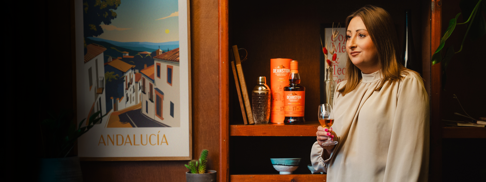 Woman holding a glass of wine in a room with Andalucía decor